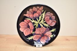 A Moorcreoft Pottery plate, of slightly dished circular form tube-lined in the anenome pattern