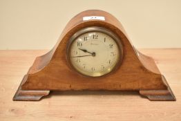 An early 20th century Arched 8 day mantel clock, decorated with inlaid stringing and raised on