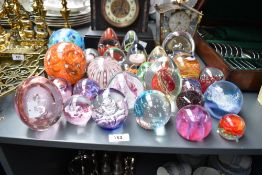 A quantity of glass paperweights, largest 11cm