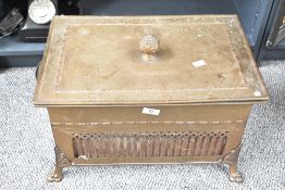 A 19th century brass coal box having pinecone handle and raised on paw feet, L47cm