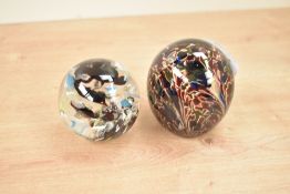 An Adsian Sankey glass dump paperweight, h6.5cm, sold together with another glass paperweight, (2)