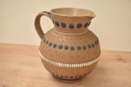 A Doulton Lambeth Silicon Ware jug, having floral patterns and impressed mark to base, h17cm