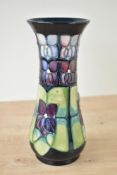 A Moorcroft pottery 'Violet' pattern vase, having painted and impressed marks to base, h20.5cm