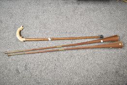 A vintage walking stick having carved fish handle, L88cm, sold together with a pair of copper
