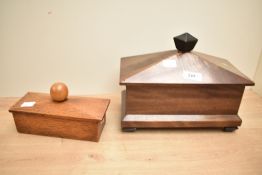 A 20th century mahogany tea caddy, of sarcophagus form with unusual sliding cover and screw