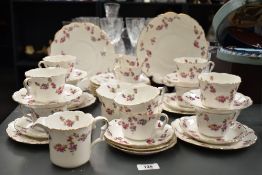An attractive bone china tea service, having gilt edge and floral patterns, to include plates,