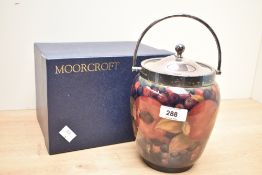 A Moorcroft 'Pomegranate' pattern biscuit barrel having plated cover and handle, painted marks to