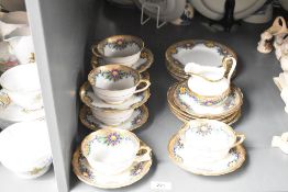 A Chelson fine bone china tea service, having gilt edges and handles, decorated with floral