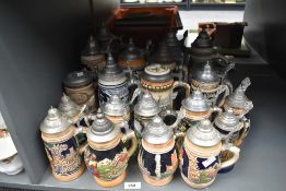 A quantity of Gerz West German lidded beer stein's, decorated in a variety of scenes including