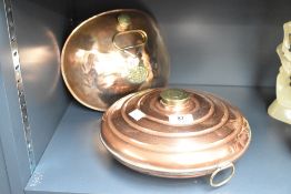 A 19th/early 20th century copper bed warmer of circular form, having brass ring handle and lid,