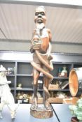 An African tribal wooden statue depicting male figure and serpent, h63cm