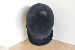 A vintage Derby House Saddlery riding hat in plush black velvet, black bow applique to rear, size