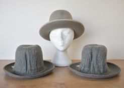 Three vintage fedora hats, two of which are grey tweed with tags still attached, both size 6 3/4,