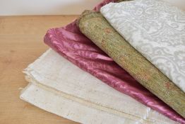 A quantity of fabrics in a range of patterns and fibres, including florals, flecked cotton, silver