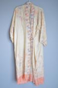 A 1920-1930s silk kimono-style robe, in blush pink rose colour, with lilac, purple and vivid coral