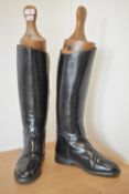 A pair of vintage Regents riding boots with antique wooden trees. Made in England boots, in black