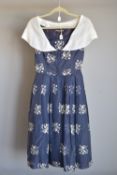 A 1950s Susan Small of London dress, in sheer navy with cream floral embroidered motif, having a