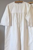 Three vintage night dresses in white cotton, two smock styles and another, having various styles