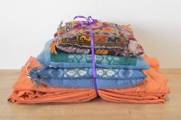 Three vintage woolen scatter cushions, including two blues and green woven examples and a warm toned