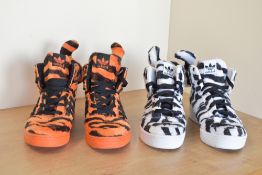 Two pairs of Jeremy Scott for Adidas high-top trainers sneakers, in tiger and zebra print fur
