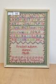A framed needlework sampler dated 1868, with local interest, having been performed by Isabella Ann