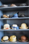Thirteen vintage straw and paper woven hats, mostly in natural, black, browns, or navy.