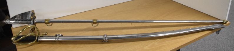 Two replica swords, one a 19th Century-type cavalry sabre, classic curved blade 83cm, overall