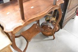An early 20th Century mahogany occasional table having shaped top and undertier , and a cane