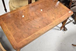 A reproduction walnut coffee table in the Regency style, approx. 97 x 51cm