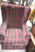 A modern wing back easy chair having burgundy check upholstery