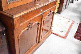 A 19th Century mahogany bookcase having glazed top over drawer and double cupboard , approx.