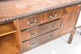 An early 20th Century mahogany sideboard having gadrooned decoration and ball and claw feet, width