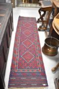 A Persian style carpet runner, approx. 253 x 62cm