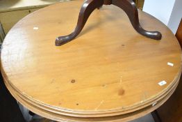 A traditional pine pedestal dining table having circular top and triple splay legs, diameter approx.