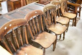 A harlequin set of five (three and two) solid seat kitchen chairs, probably 19th Century