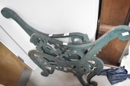 A pair of ornate cast iron bench ends
