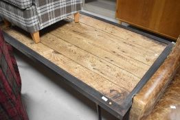 A Restoration Hardware plank style coffee table in the Industrial style having metal frame, approx