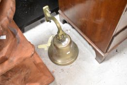 A large brass bell, pub style with wall bracket