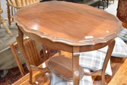 An early 20th century mahogany occasional table having shaped top and undertier