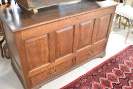 A Georgian oak kist having four panels over two drawers, on bracket feet, width 126cm