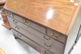 A Georgian mahogany bureau of wide proportions, having fitted interior, brass drop handles, on