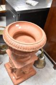 A traditional terracotta garden urn on plinth, height approx. 78cm