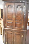 A late 19th or early 20th Century oak full height corner cupboard, height approx. 192cm