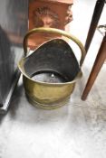 A traditional brass coal scuttle