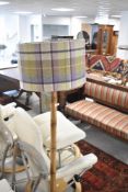 A traditional standard lamp having turned column (bamboo effect), width modern tweed shade