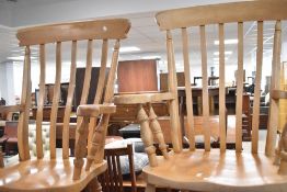 A pair of vintage Windsor style beech armchairs having shaped rail backs