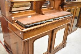 A Victorian pollard oak bookcase having glaxed top over central riser with mirror to back and base