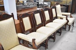 A Victorian mahogany framed salon suite comprising four dining chairs and two easy chairs, with