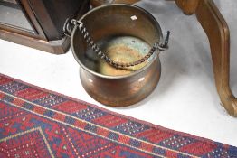 An antique copper pot, having chain handle, height approx. 28cm