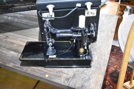A vintage Singer 221K sewing machine, in case